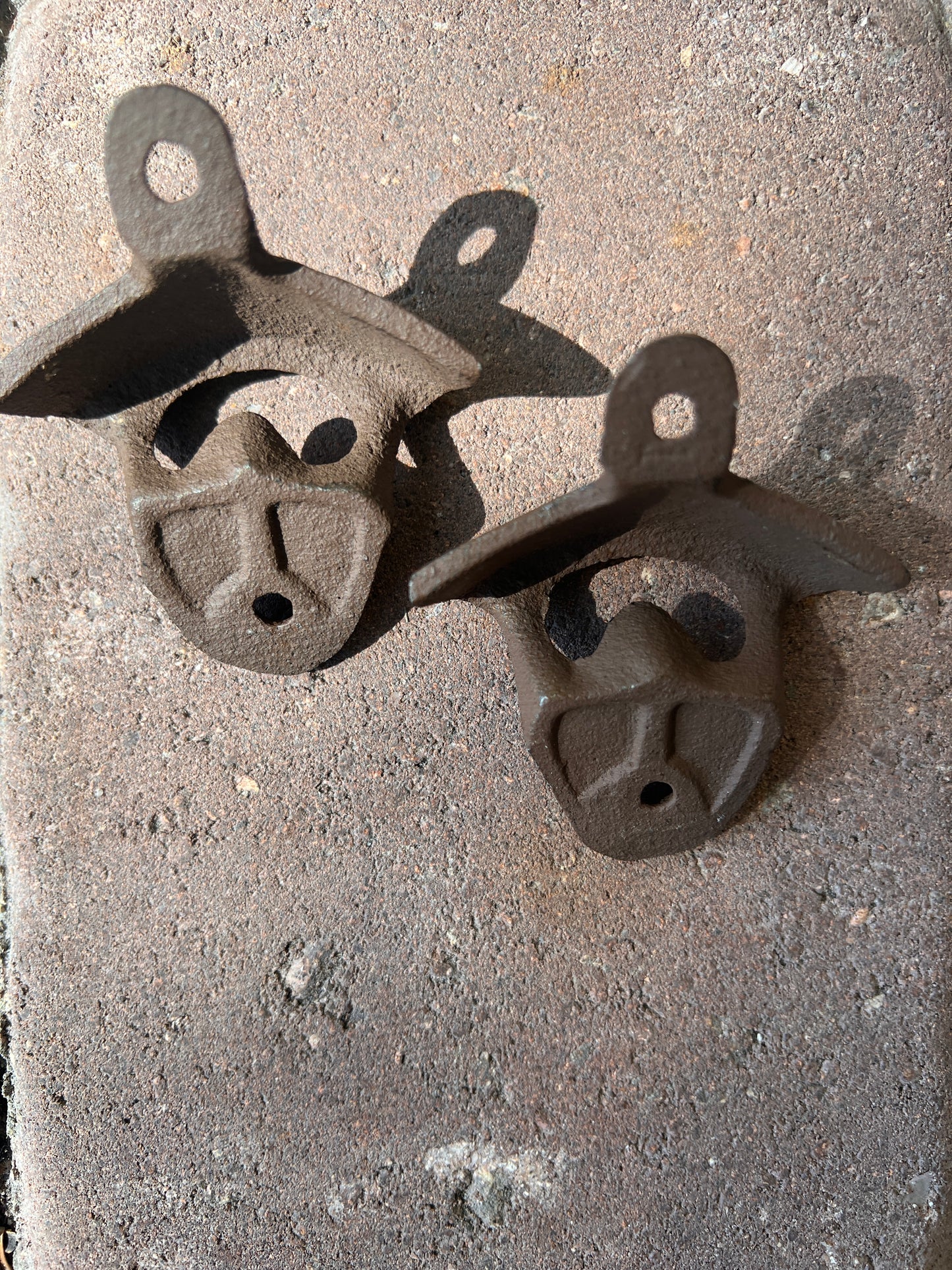 Cast iron wall mount bottle opener showing mounting detail — vintage style bar accessory