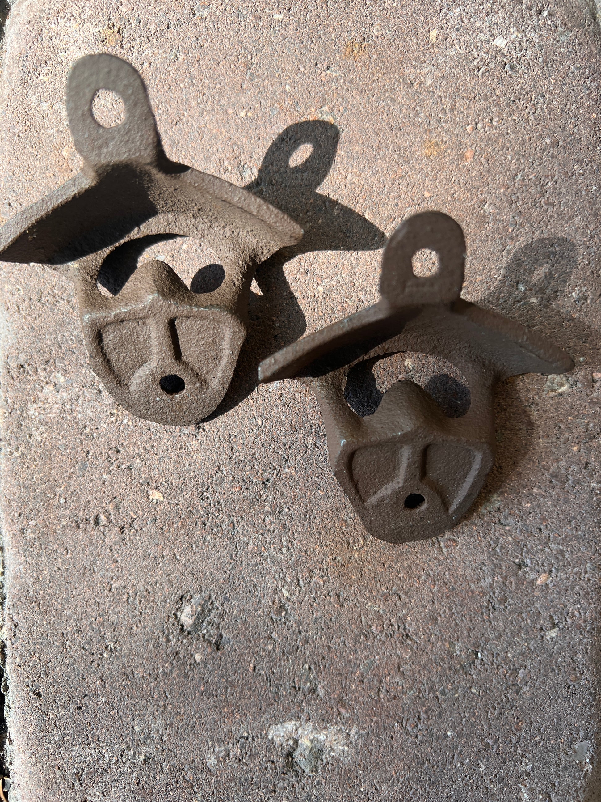 Cast iron wall mount bottle opener showing mounting detail — vintage style bar accessory